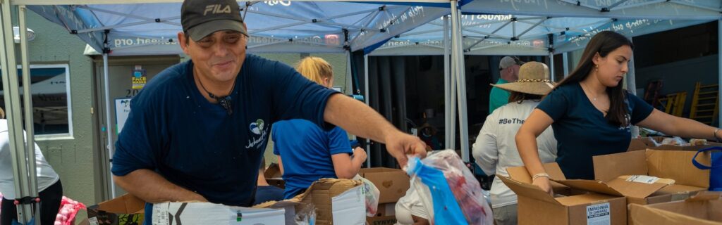 A group of volunteers filling boxes with supplies