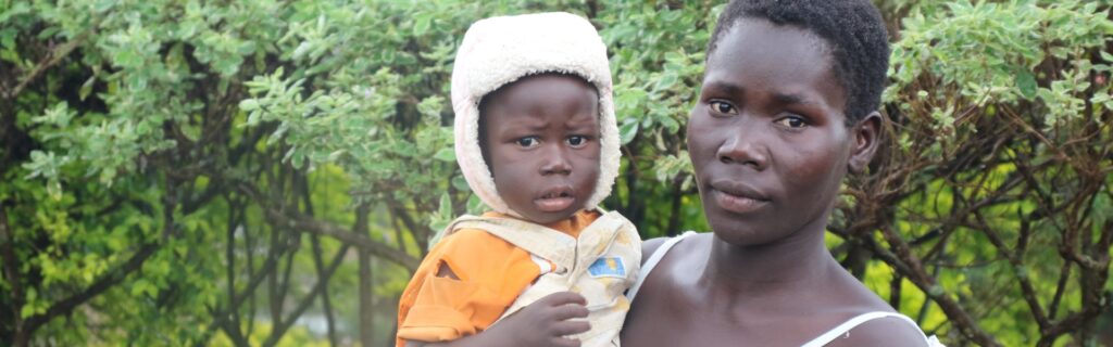 A mother holding her child outdoors in Africa