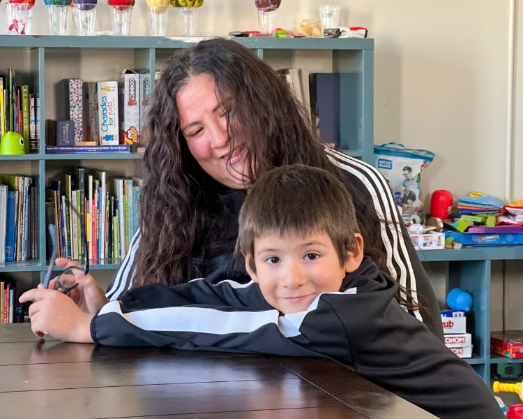 Lily and her son sitting at a table