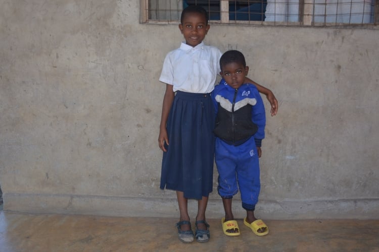 A girl and boy standing together