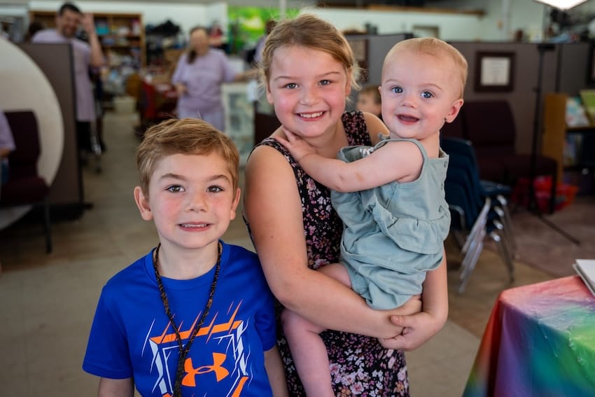 Three children at an outdoor event