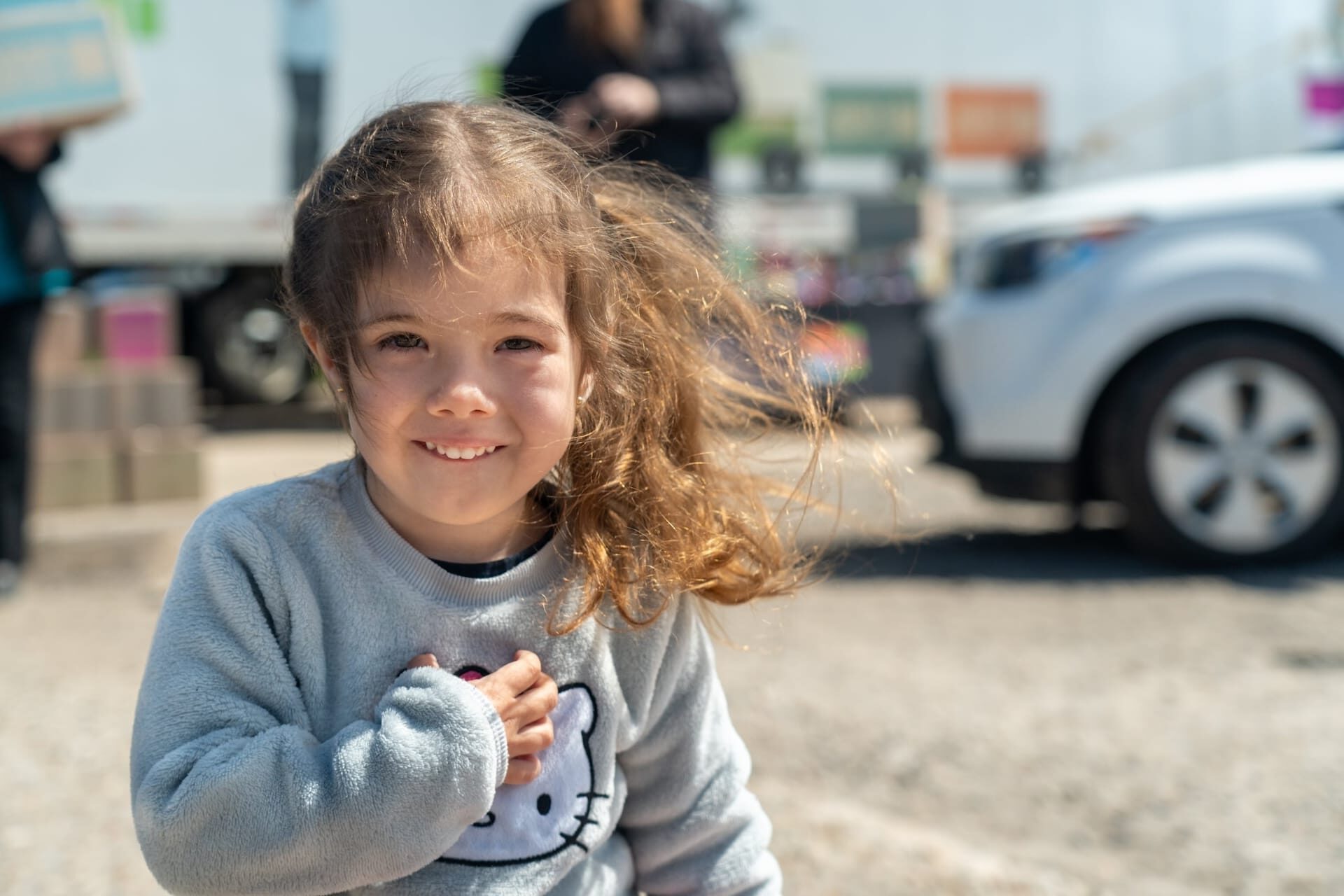 A child smiling at an outdoor event