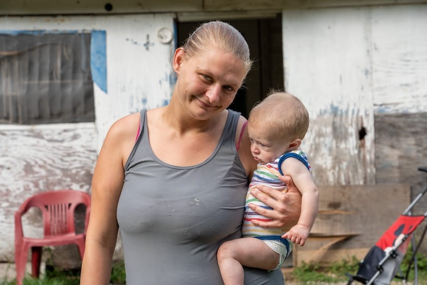 A mother holding her child outdoors