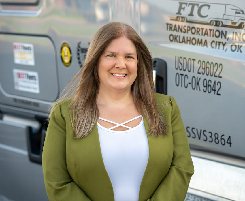 Emory Mills standing in front of a truck