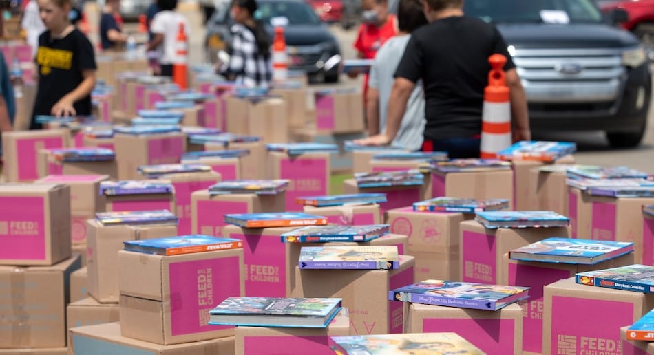 Boxes and books stacked outdoors at an event