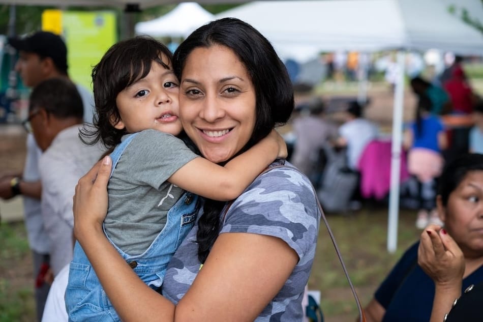 A mother and child hugging at an event