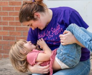 A mother and daughter playing together outdoors