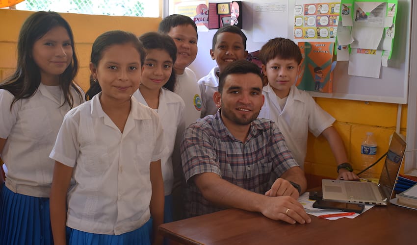 A group of children and teacher in a school classroom