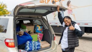 A woman with a car loaded with food supplies in Detroit