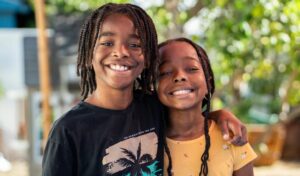 Two children hugging outdoors